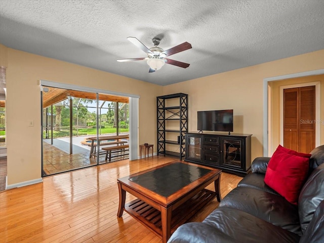 4118 Carrollwood Village Dr, Tampa, FL 33618 - living area featuring ceiling fan, wood finished floors, and a textured ceiling