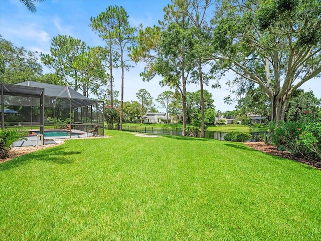 4118 Carrollwood Village Dr, Tampa, FL 33618 - view of yard featuring an outdoor pool, glass enclosure, and a water view
