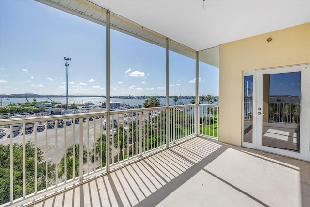 423 150th Ave Unit 1501, Madeira Beach, FL 33708 - unfurnished sunroom featuring a water view