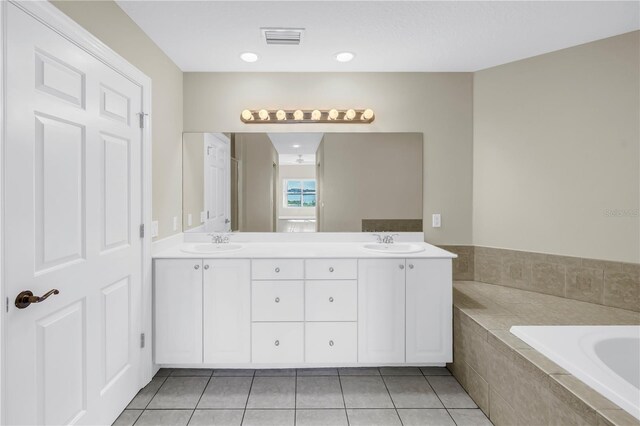 423 150th Ave Unit 1501, Madeira Beach, FL 33708 - bathroom featuring a garden tub, double vanity, and tile patterned floors