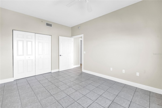 423 150th Ave Unit 1501, Madeira Beach, FL 33708 - unfurnished bedroom featuring a closet, light tile patterned flooring, and a ceiling fan