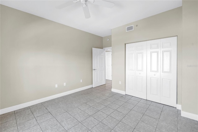 423 150th Ave Unit 1501, Madeira Beach, FL 33708 - unfurnished bedroom featuring light tile patterned floors, a closet, and ceiling fan