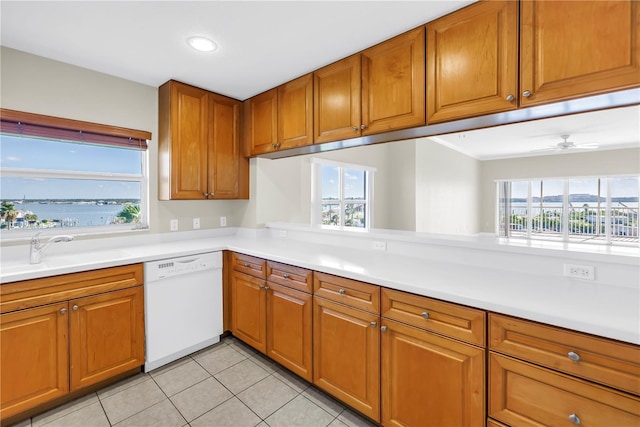 423 150th Ave Unit 1501, Madeira Beach, FL 33708 - kitchen featuring white dishwasher, brown cabinets, light tile patterned floors, light countertops, and recessed lighting