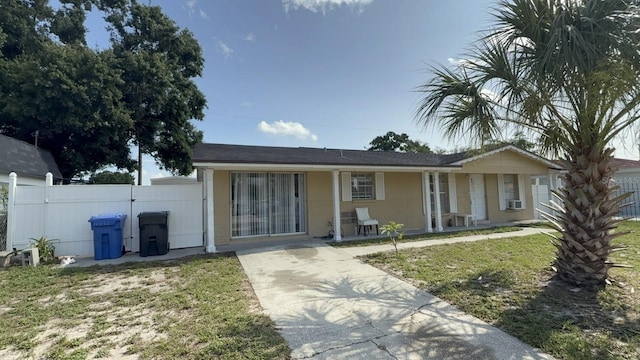 7206 Reindeer Rd, Tampa, FL 33619 - ranch-style house featuring driveway, brick siding, cooling unit, and covered porch