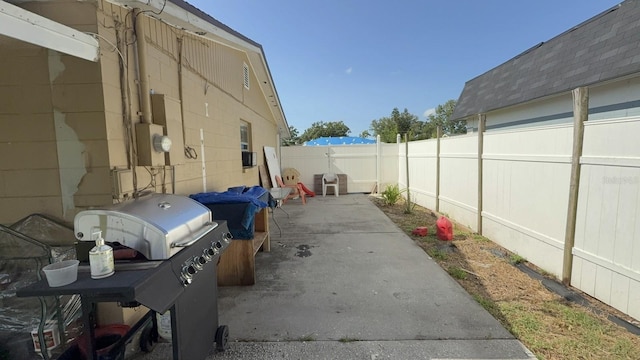 7206 Reindeer Rd, Tampa, FL 33619 - fenced backyard with a grill and a patio