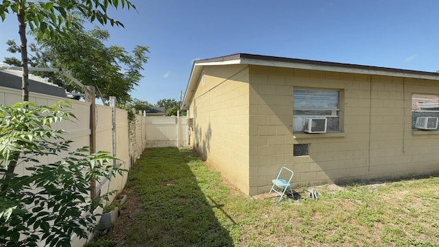 7206 Reindeer Rd, Tampa, FL 33619 - view of side of property with cooling unit, a fenced backyard, and concrete block siding