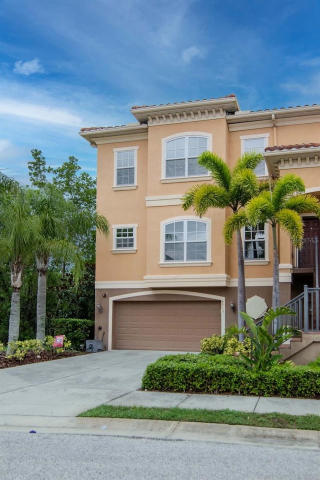 6513 Sand Shore Ln, New Port Richey, FL 34652 - view of front of home with an attached garage, stucco siding, concrete driveway, and a tile roof