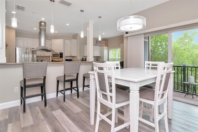 6513 Sand Shore Ln, New Port Richey, FL 34652 - dining area featuring light wood finished floors and recessed lighting