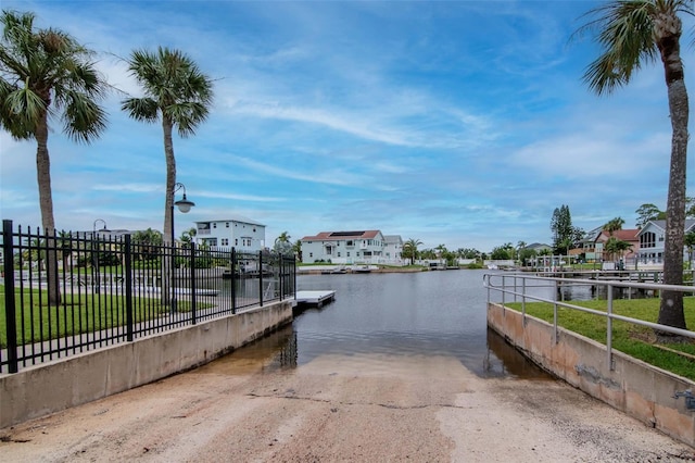 6513 Sand Shore Ln, New Port Richey, FL 34652 - dock area featuring a boat ramp, a water view, and a residential view