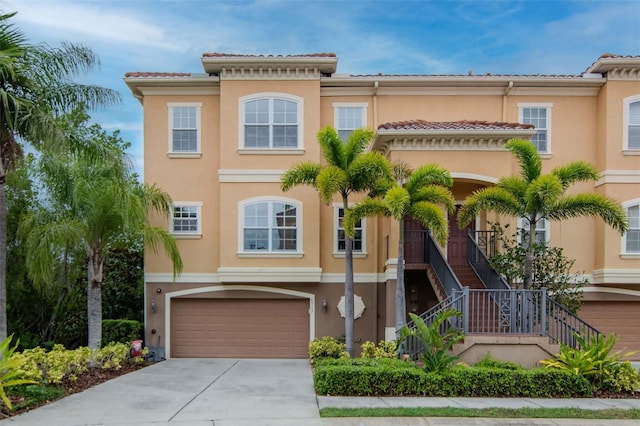 6513 Sand Shore Ln, New Port Richey, FL 34652 - view of front of house featuring a garage, stucco siding, driveway, and stairway