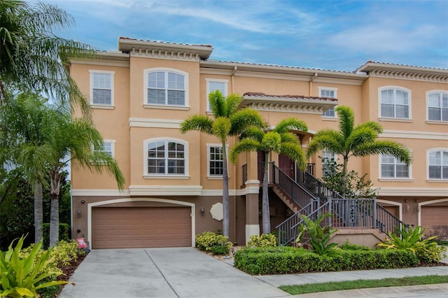 6513 Sand Shore Ln, New Port Richey, FL 34652 - view of front of property with a garage, driveway, stucco siding, and stairs