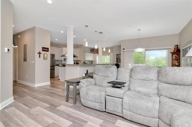 6513 Sand Shore Ln, New Port Richey, FL 34652 - living room with light wood-style flooring, recessed lighting, and electric panel