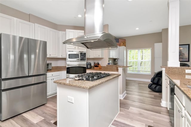 6513 Sand Shore Ln, New Port Richey, FL 34652 - kitchen featuring appliances with stainless steel finishes, ornate columns, island exhaust hood, white cabinets, and recessed lighting