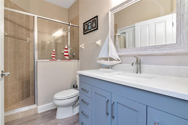 6513 Sand Shore Ln, New Port Richey, FL 34652 - bathroom featuring vanity, a stall shower, and wood finished floors