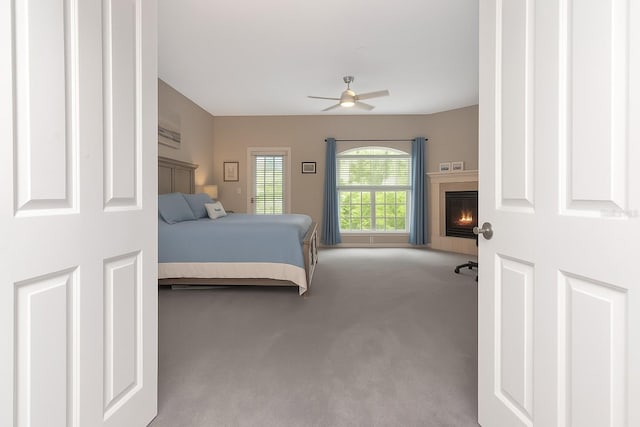 6513 Sand Shore Ln, New Port Richey, FL 34652 - bedroom with carpet, a fireplace, and a ceiling fan