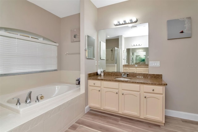 6513 Sand Shore Ln, New Port Richey, FL 34652 - full bathroom featuring a shower stall, a bath, vanity, and wood finished floors