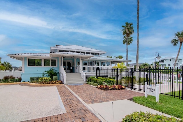 6513 Sand Shore Ln, New Port Richey, FL 34652 - view of front facade featuring a metal roof and a porch