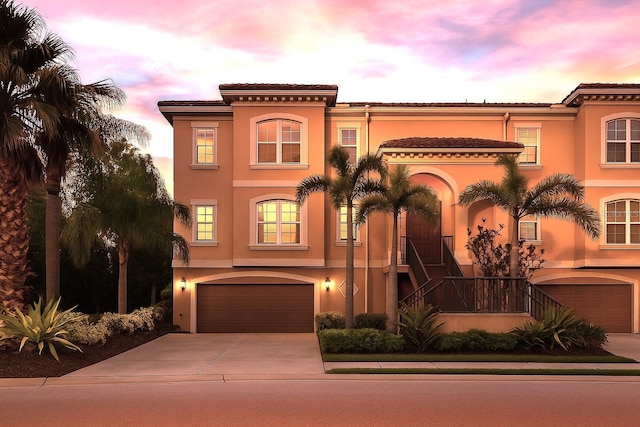 6513 Sand Shore Ln, New Port Richey, FL 34652 - mediterranean / spanish house featuring stucco siding, a garage, and concrete driveway
