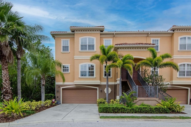 6513 Sand Shore Ln, New Port Richey, FL 34652 - view of front of house featuring an attached garage, stucco siding, and driveway