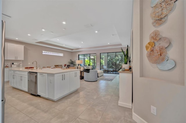5320 Morey Farms Loop, Palmetto, FL 34221 - kitchen featuring a tray ceiling, open floor plan, white cabinets, light countertops, and recessed lighting