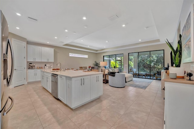 5320 Morey Farms Loop, Palmetto, FL 34221 - kitchen featuring a tray ceiling, appliances with stainless steel finishes, open floor plan, light tile patterned floors, and recessed lighting