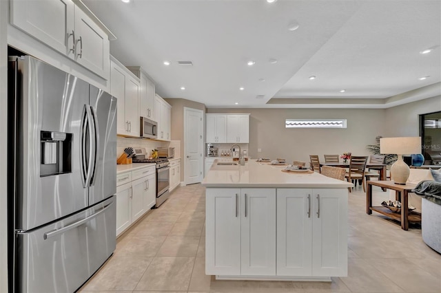 5320 Morey Farms Loop, Palmetto, FL 34221 - kitchen featuring appliances with stainless steel finishes, backsplash, light tile patterned floors, white cabinets, and light countertops