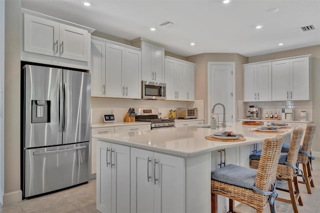 5320 Morey Farms Loop, Palmetto, FL 34221 - kitchen featuring stainless steel appliances, tasteful backsplash, light countertops, white cabinets, and recessed lighting