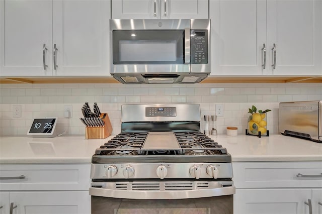5320 Morey Farms Loop, Palmetto, FL 34221 - kitchen featuring appliances with stainless steel finishes, white cabinets, and light countertops