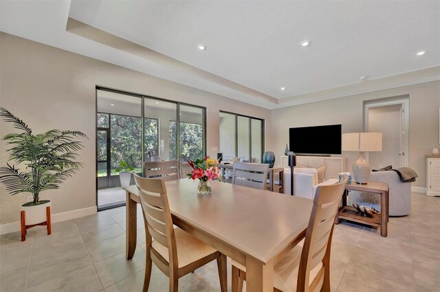 5320 Morey Farms Loop, Palmetto, FL 34221 - dining space with a tray ceiling, recessed lighting, and light tile patterned floors