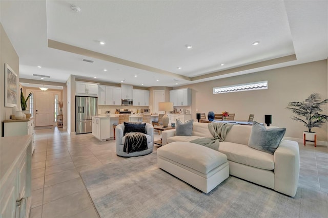 5320 Morey Farms Loop, Palmetto, FL 34221 - living room with a tray ceiling, light tile patterned floors, and recessed lighting
