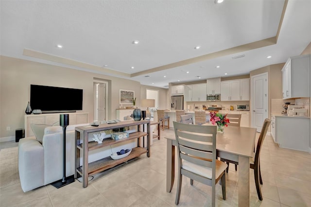 5320 Morey Farms Loop, Palmetto, FL 34221 - dining space with a tray ceiling, light tile patterned floors, and recessed lighting