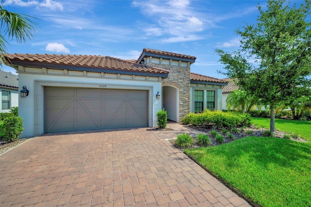5320 Morey Farms Loop, Palmetto, FL 34221 - mediterranean / spanish-style house with stucco siding, an attached garage, decorative driveway, a front lawn, and a tile roof