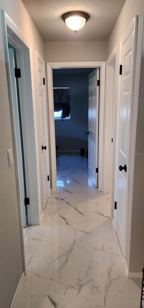 1583 Eunice Ln, Clearwater, FL 33756 - hallway with a textured ceiling and marble finish floors