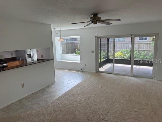 1922 Blue Sage Ct, Brandon, FL 33511 - unfurnished living room featuring a ceiling fan, light tile patterned floors, and light carpet