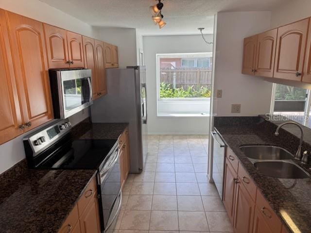 1922 Blue Sage Ct, Brandon, FL 33511 - kitchen with stainless steel appliances, dark stone countertops, and light tile patterned floors