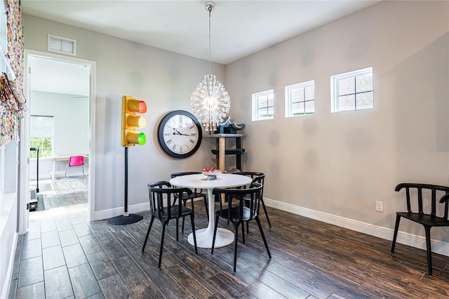 6817 Ebb Tide Ave, Apollo Beach, FL 33572 - dining space featuring dark wood-style flooring, healthy amount of natural light, and a chandelier