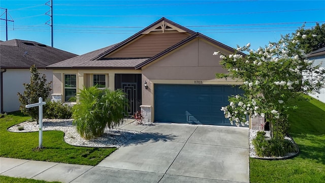 11703 Brighton Knoll Loop, Riverview, FL 33579 - single story home featuring stucco siding, an attached garage, concrete driveway, and a front lawn