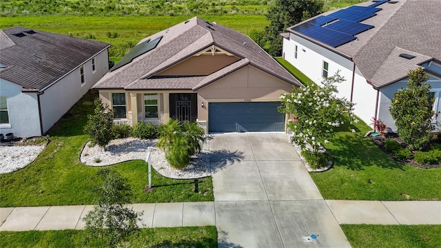 11703 Brighton Knoll Loop, Riverview, FL 33579 - view of front facade featuring driveway, an attached garage, roof with shingles, and a front yard