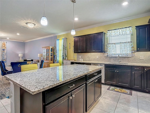 11703 Brighton Knoll Loop, Riverview, FL 33579 - kitchen with light tile patterned flooring, decorative backsplash, dishwasher, light stone counters, and a kitchen island