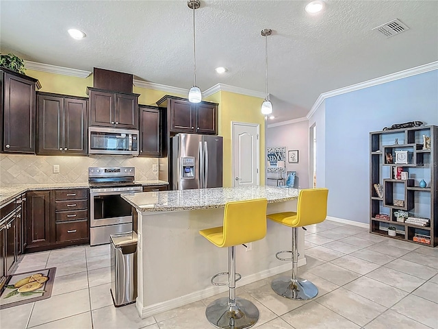 11703 Brighton Knoll Loop, Riverview, FL 33579 - kitchen with appliances with stainless steel finishes, a center island, ornamental molding, light stone countertops, and tasteful backsplash