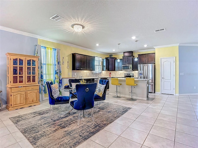 11703 Brighton Knoll Loop, Riverview, FL 33579 - dining room featuring light tile patterned floors, crown molding, recessed lighting, and a textured ceiling