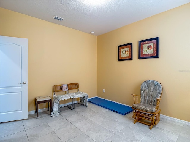 11703 Brighton Knoll Loop, Riverview, FL 33579 - sitting room featuring light tile patterned flooring and a textured ceiling