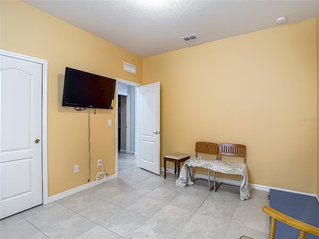 11703 Brighton Knoll Loop, Riverview, FL 33579 - bedroom with light tile patterned floors and a textured ceiling