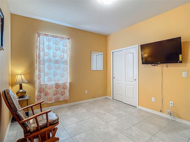 11703 Brighton Knoll Loop, Riverview, FL 33579 - sitting room featuring a textured ceiling and light tile patterned floors
