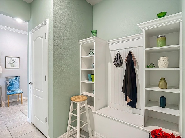 11703 Brighton Knoll Loop, Riverview, FL 33579 - mudroom with light tile patterned floors, a textured wall, and ornamental molding
