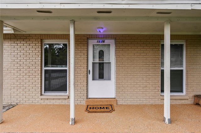 1116 Jadewood Ave, Clearwater, FL 33759 - doorway to property with brick siding and covered porch