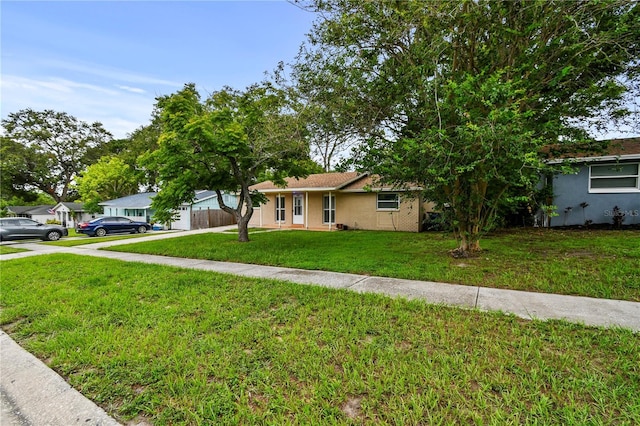 1116 Jadewood Ave, Clearwater, FL 33759 - ranch-style home with driveway, a front lawn, and stucco siding