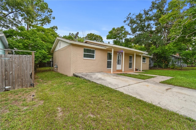 1116 Jadewood Ave, Clearwater, FL 33759 - ranch-style house featuring brick siding, a porch, and concrete driveway