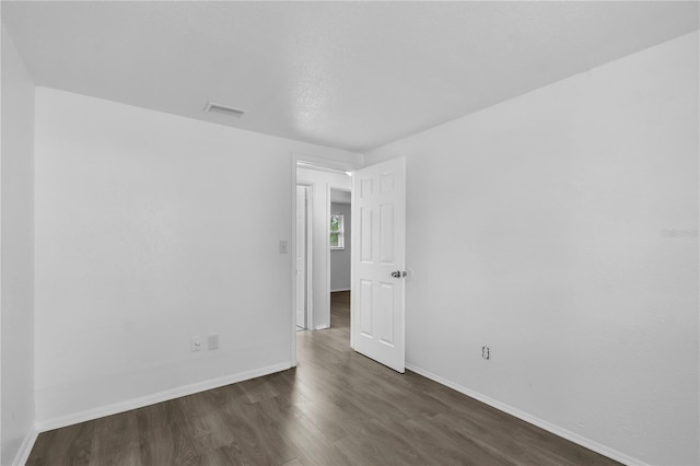1116 Jadewood Ave, Clearwater, FL 33759 - unfurnished room with dark wood-style floors and baseboards