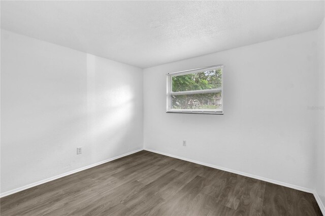1116 Jadewood Ave, Clearwater, FL 33759 - empty room with wood finished floors and baseboards